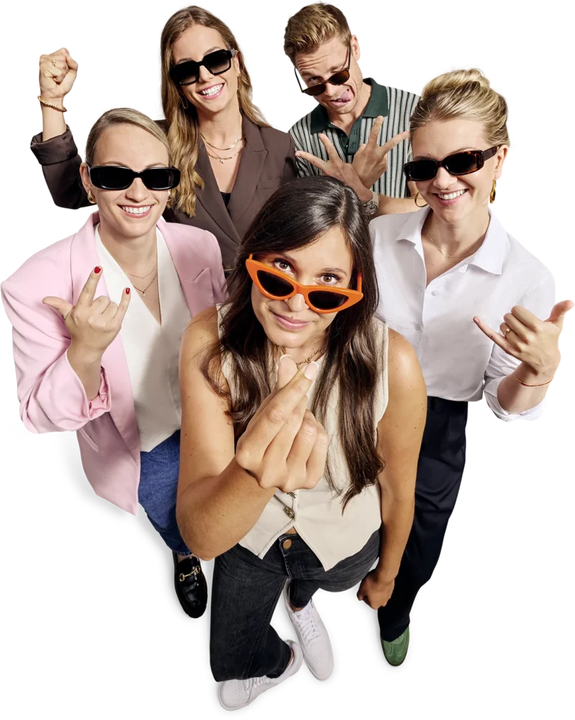 DESTVB-Team in lockerer Pose von oben: fünf Personen mit Sonnenbrillen, vorne Filiz mit verschränkten Fingern.